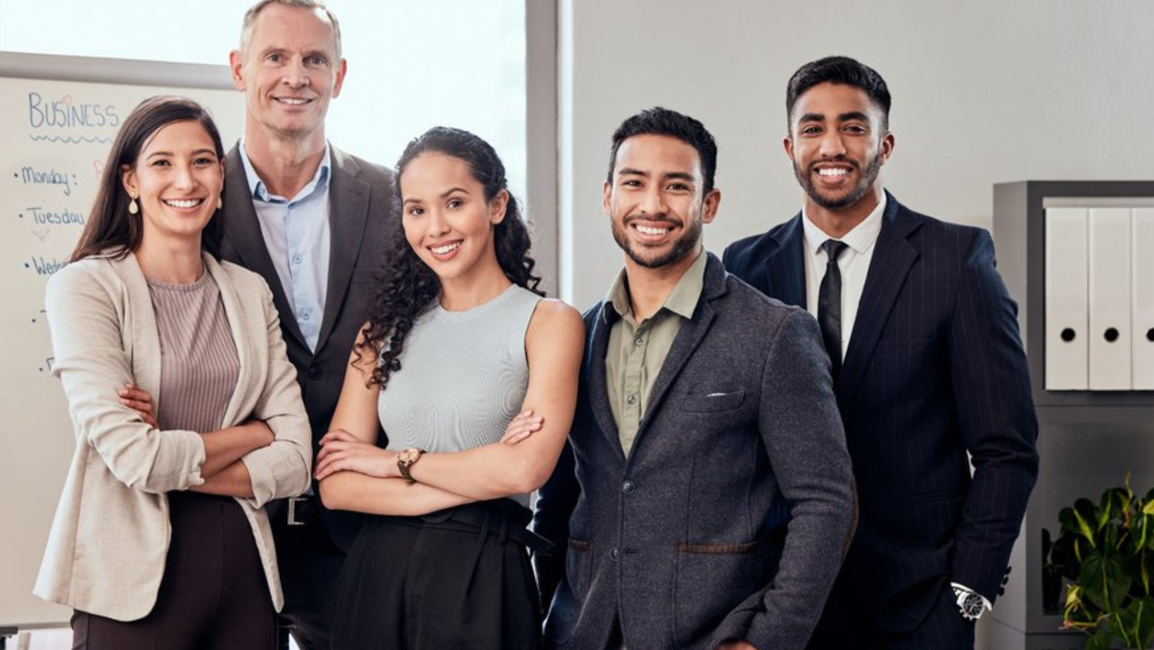 Ascend Adwerks' team members standing together in an office.