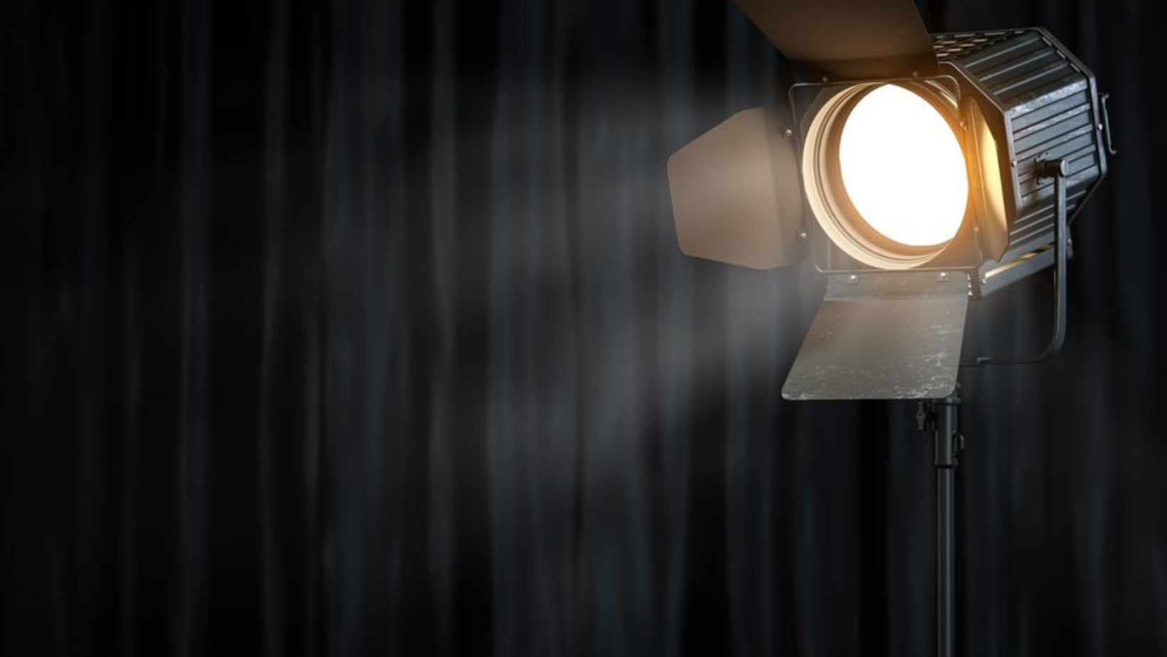 An image of a stage and a lone spotlight that represents spotlighting local Boise Idaho businesses.