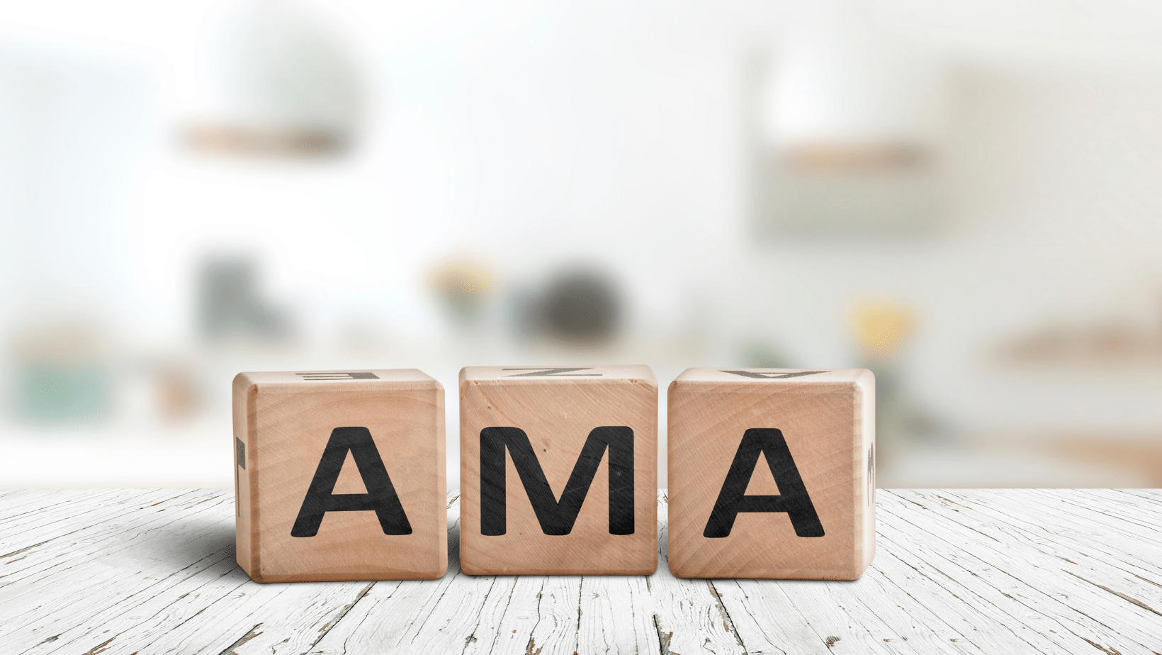 Ascend Adwerks image of wooden blocks spelling the word ama on a wooden table symbolizes Reddit AMA Marketing.