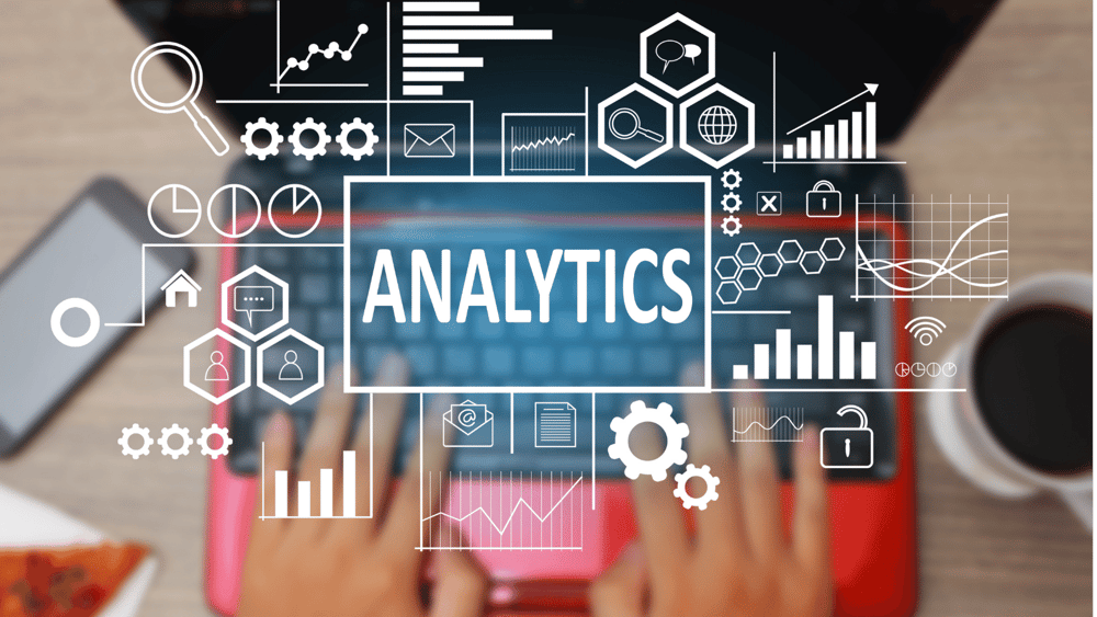 Analytics on an Ascend Adwerks' laptop with a coffee cup in the background.