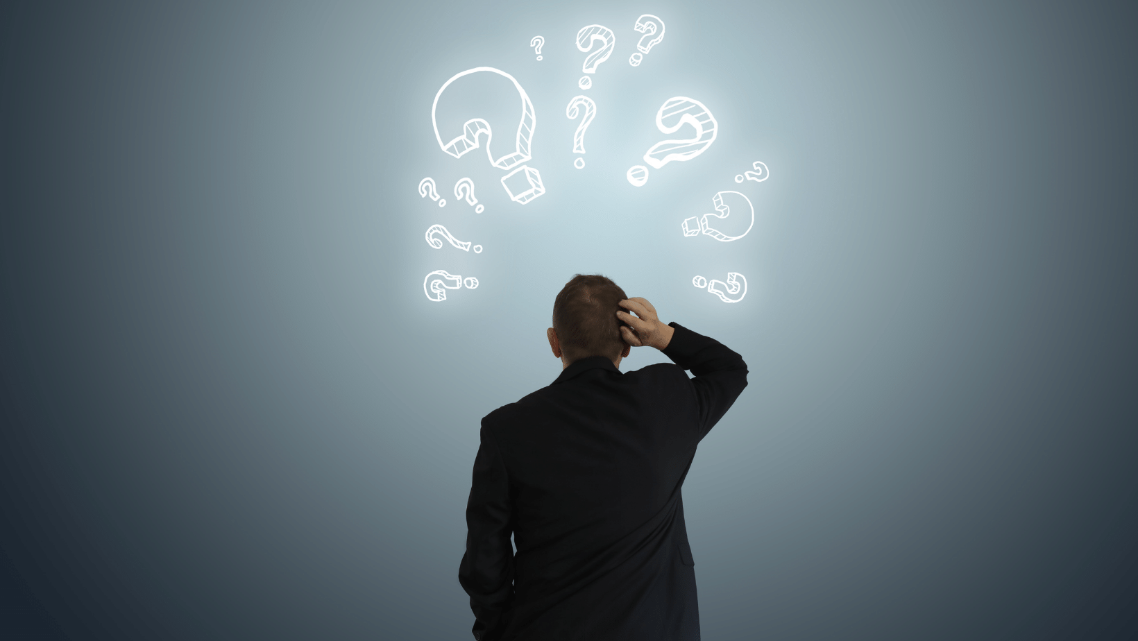 Ascend Adwerks' team member in a suit looking at question marks above their head.