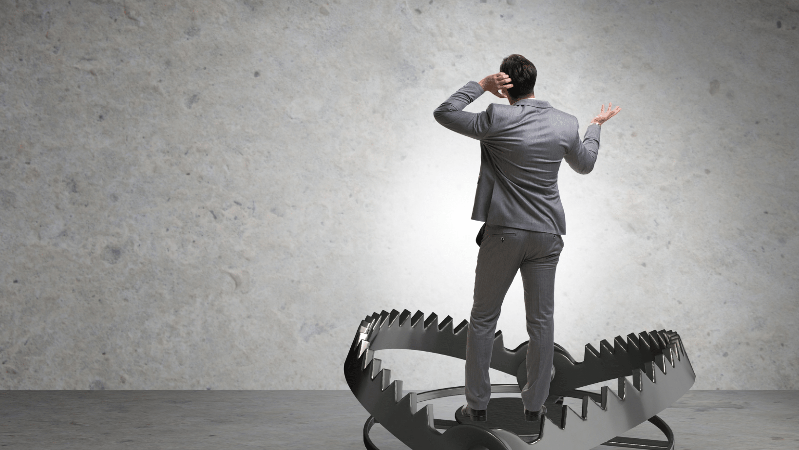 A person in a suit standing on top of a large bear trap represents dta pitfalls for small businesses.