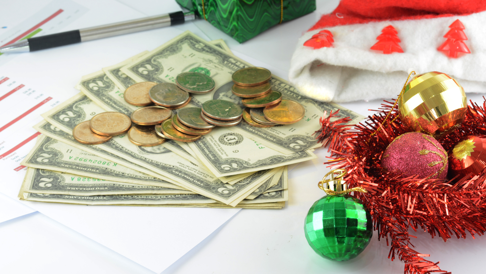 Ascend Adwerks’ image of a santa hat, money and christmas decorations on a desk.