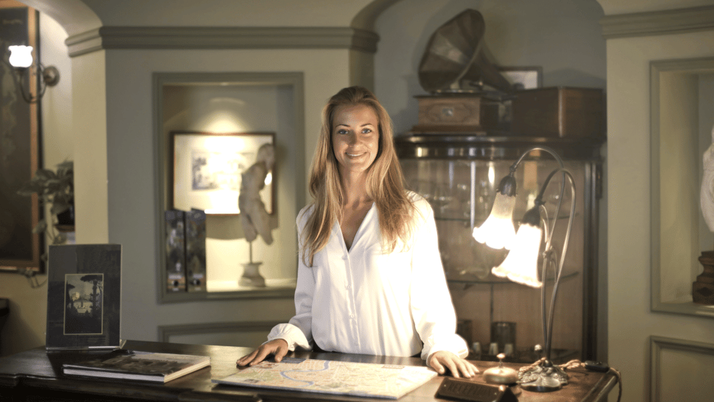 A person standing in front of a desk at a hotel symbolizes digital marketing services for the hospitality industry.