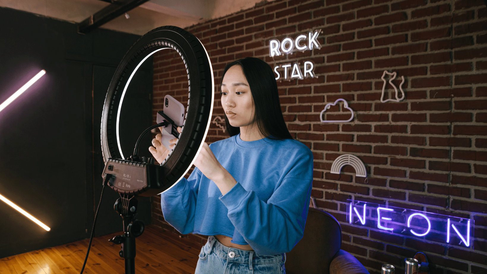 A person sitting in front of a video camera on a tripod symbolizes Ascend Adwerks' influencer marketing services.