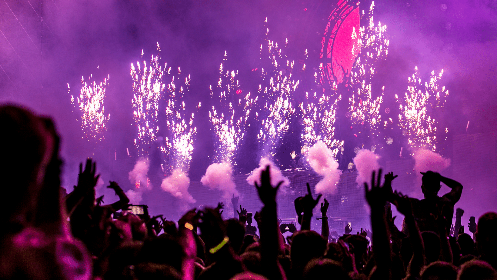 An Ascend Adwerks' image of a crowd of people at a concert with fireworks in the background.
