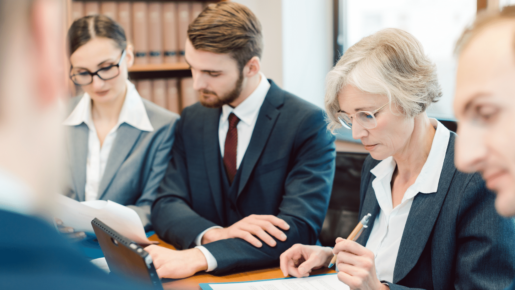 Ascend Adwerks' law firm clients sitting at a table discussing digital marketing services.