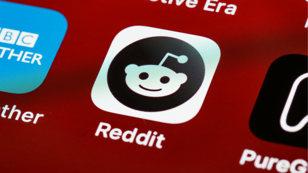 Ascend Adwerks' image of a close up of the Reddit app on a phone symbolizing specialized Reddit Marketing.