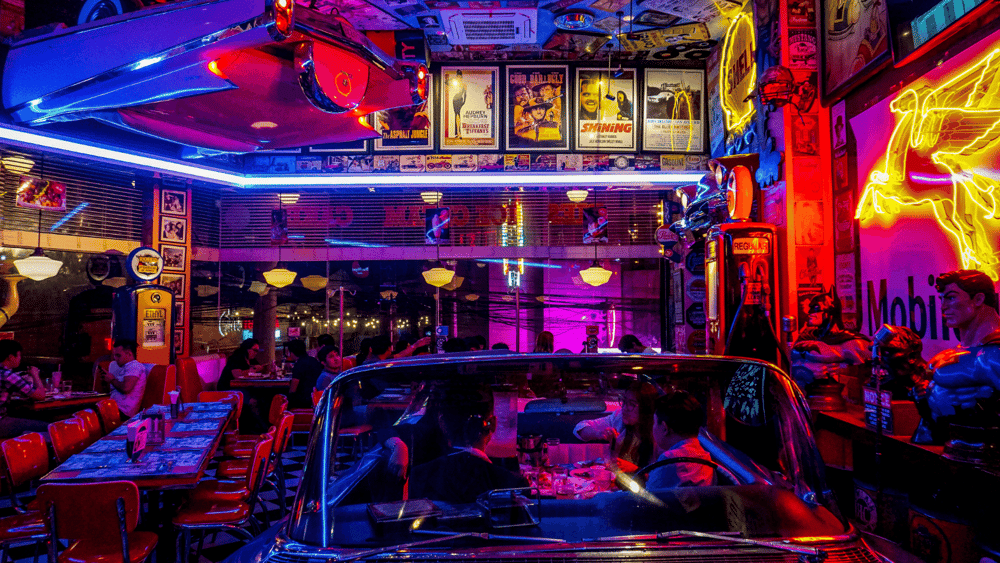 Ascend Adwerks' image of a restaurant with neon lights and neon signs on the walls.