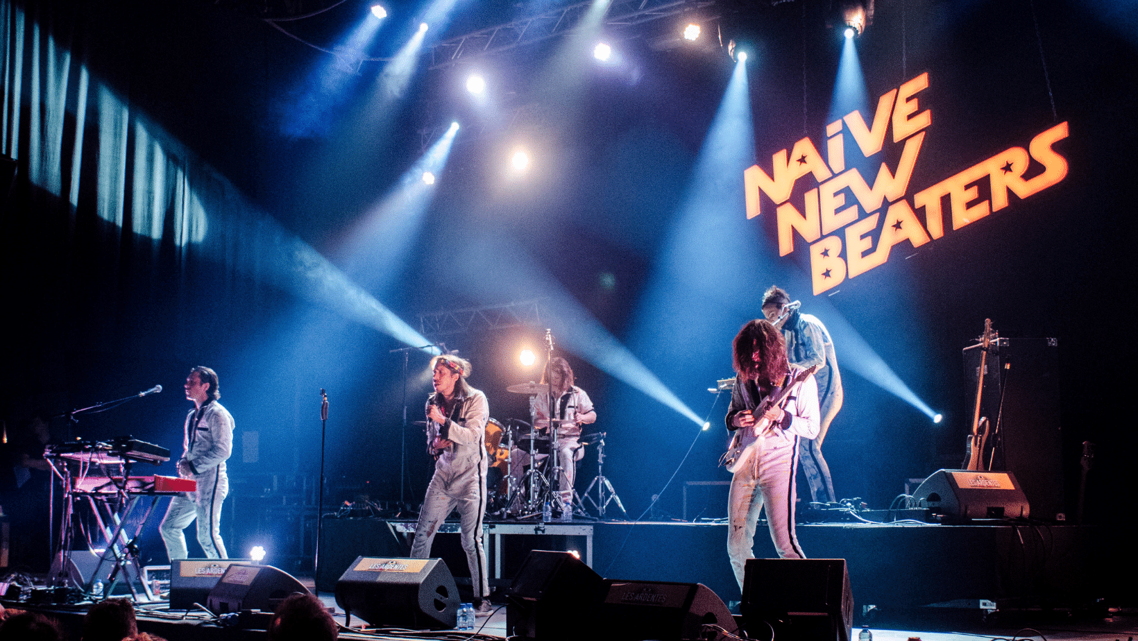 A group of people on stage at a concert symbolizes Ascend Adwerks' entertainment marketing services.