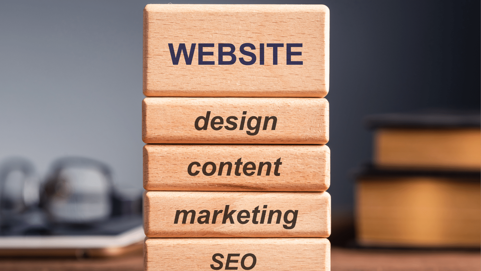 Wooden blocks with 'website design, content marketing, and search engine optimization' written on them.